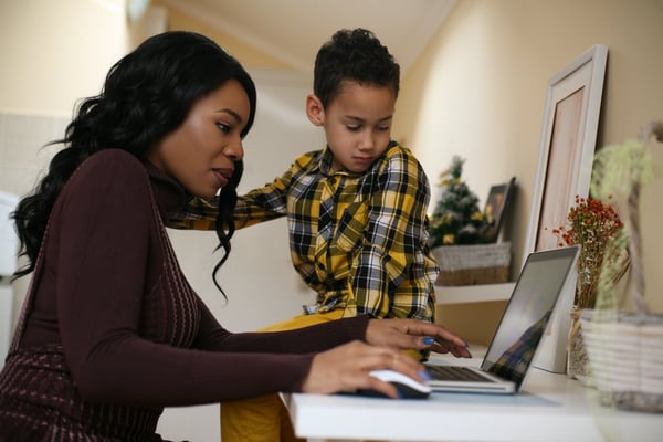 Woman on laptop with son